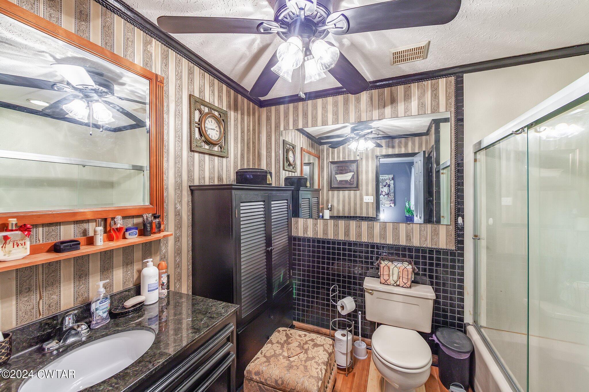 93 Lohrig Road Jackson, TN 38301 - Photo 16 of 27 a bathroom with a toilet a sink and a shower