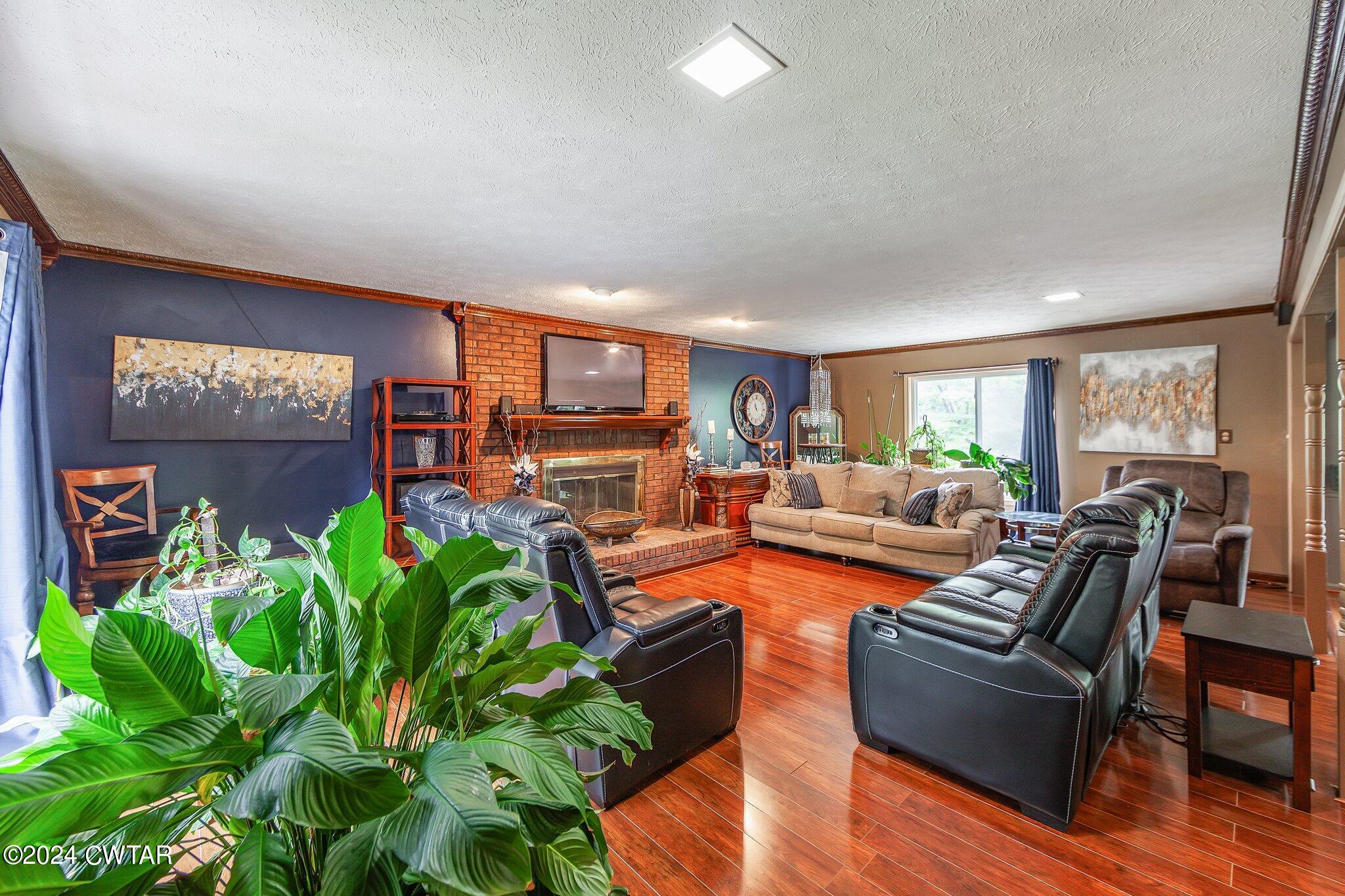 93 Lohrig Road Jackson, TN 38301 - Photo 4 of 27 a living room with fireplace furniture and a potted plant