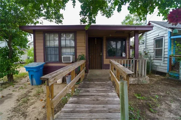 a view of a house with a wooden deck