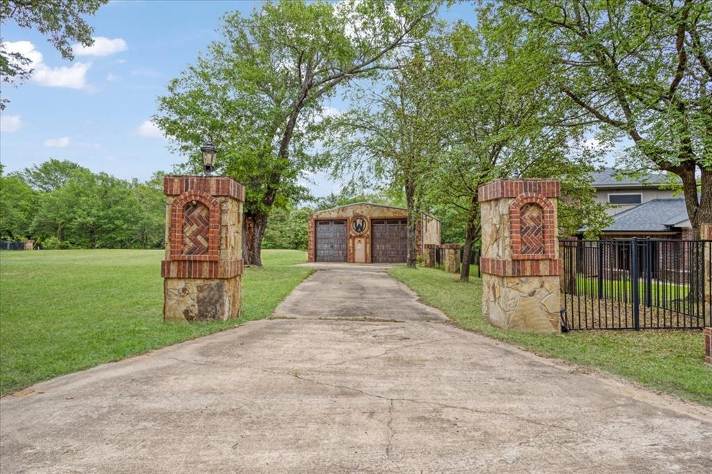 380 Timber Lakes Drive Powderly, TX 75473 - Photo 2 of 19 a pathway of a house with a yard