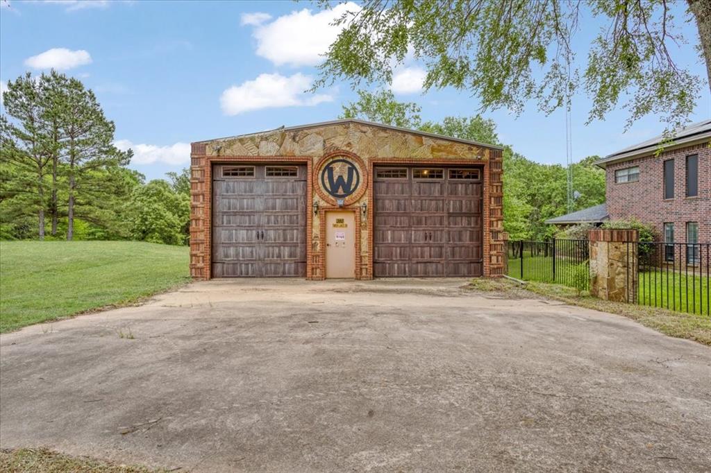 380 Timber Lakes Drive Powderly, TX 75473 - Photo 3 of 19 a view of a house with a yard and garage