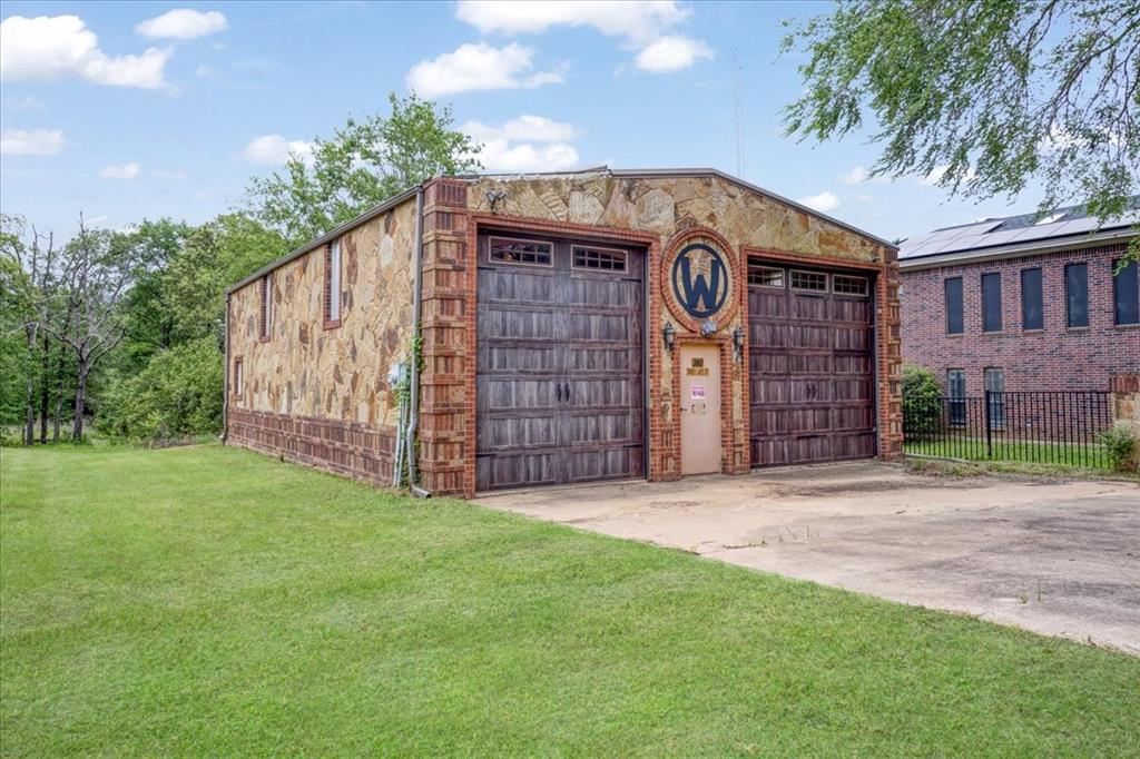 380 Timber Lakes Drive Powderly, TX 75473 - Photo 4 of 19 a front view of a house with garden