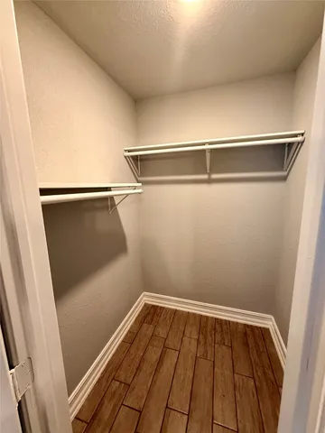 a view of a room with wooden floor and cabinetry