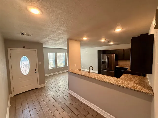 a large hall with a large mirror and sink