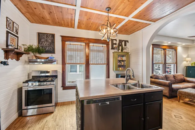 a kitchen with a sink appliances and a counter top space