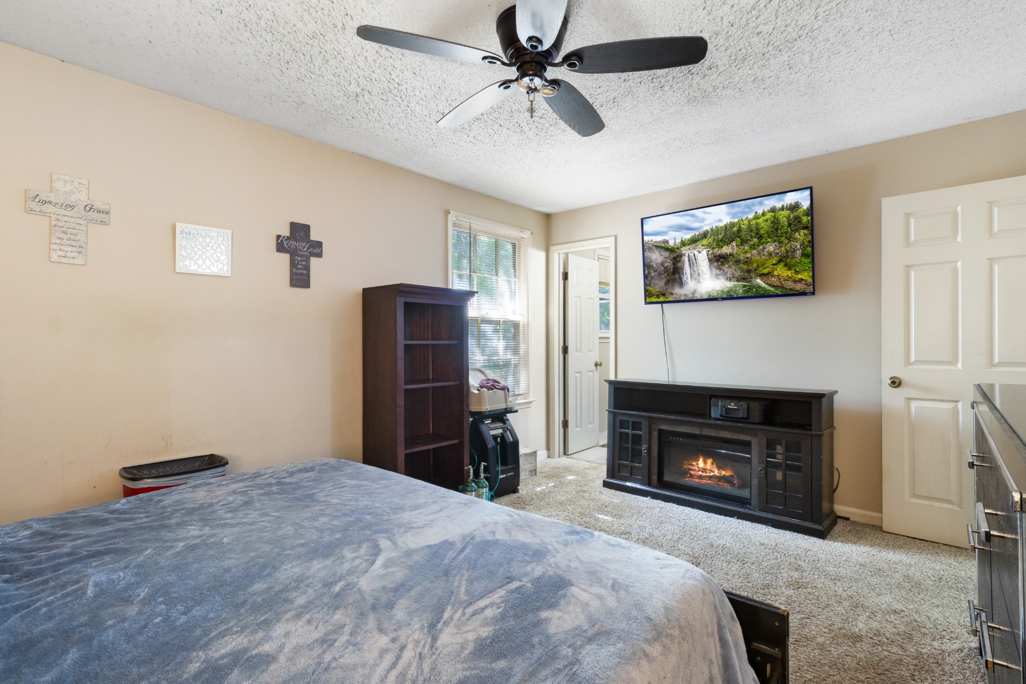 206 Pine Mountain Road Clarksville, TN 37042 - Photo 10 of 17 a bedroom with furniture a fireplace and a ceiling fan