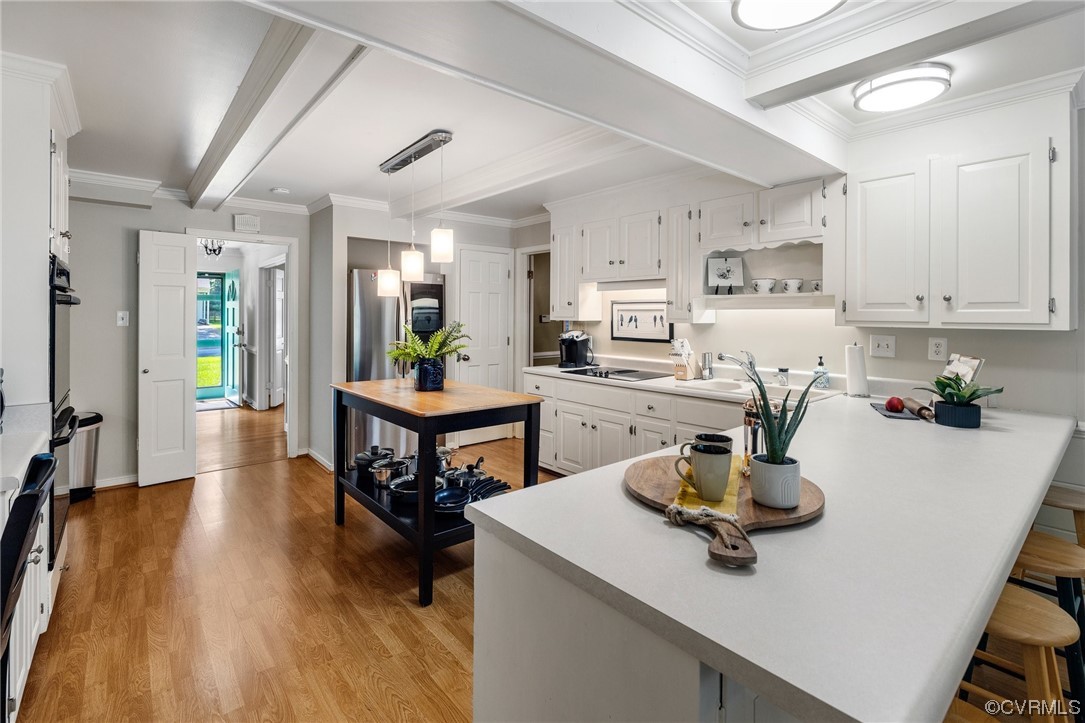 1513 Willingham Road Henrico, VA 23238 - Photo 12 of 40 a kitchen with a dining table chairs and white appliances