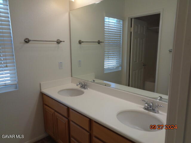 43660 Windrose Place Lancaster, CA 93536 - Photo 18 of 26 a bathroom with a sink and a mirror