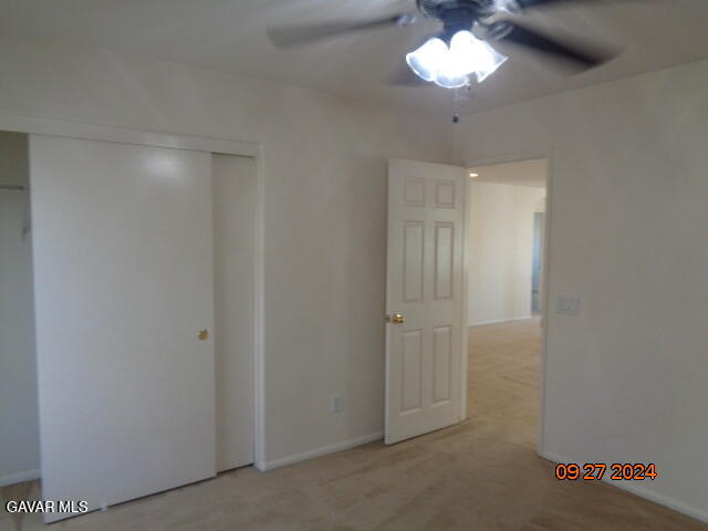 43660 Windrose Place Lancaster, CA 93536 - Photo 20 of 26 a view of an empty room with a chandelier fan