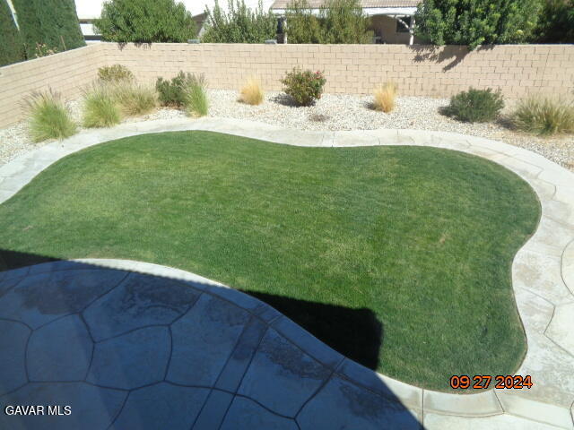 43660 Windrose Place Lancaster, CA 93536 - Photo 23 of 26 a view of a swimming pool with a yard
