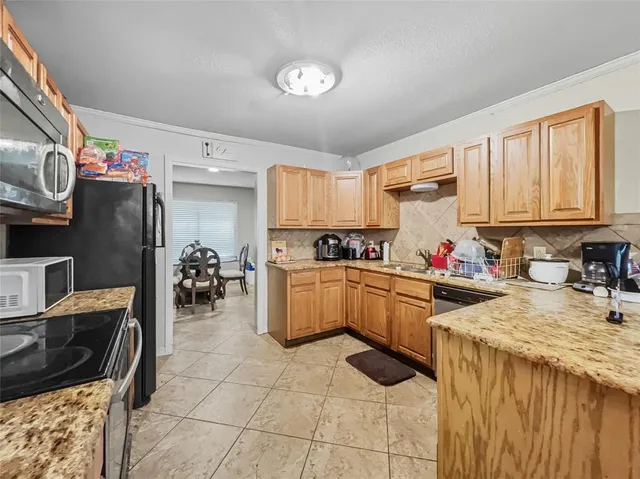 a kitchen with a sink appliances and cabinets