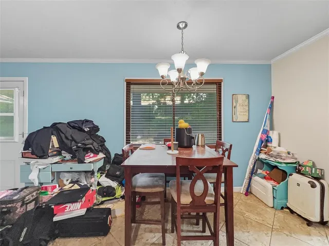 a view of a dining room with furniture wooden floor and chandelier