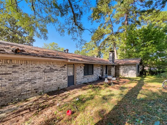 a view of a patio with table and chairs under an umbrella