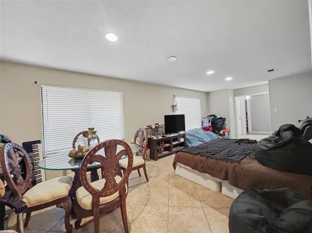 a bed room with furniture and a flat screen tv