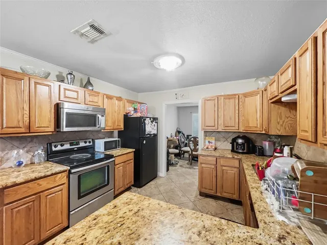 a kitchen with a stove a sink and a microwave