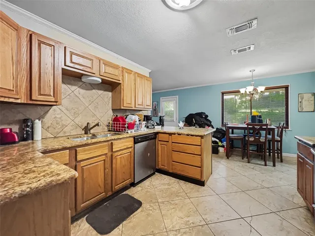 a kitchen with granite countertop cabinets a sink and a counter space