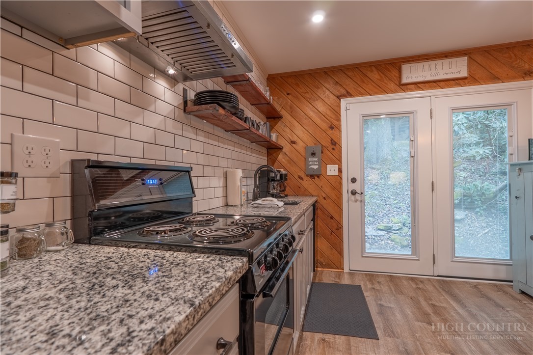 141 Snowflake Road Banner Elk, NC 28604 - Photo 17 of 28 a kitchen with stainless steel appliances granite countertop a stove a sink and a microwave
