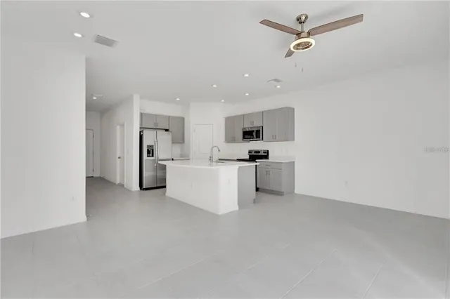 a view of kitchen with white cabinets and stainless steel appliances