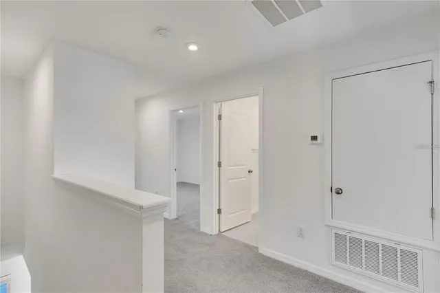 a kitchen with a sink and white cabinets