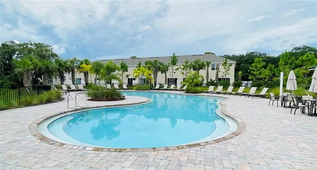 a view of a swimming pool and trees in the background