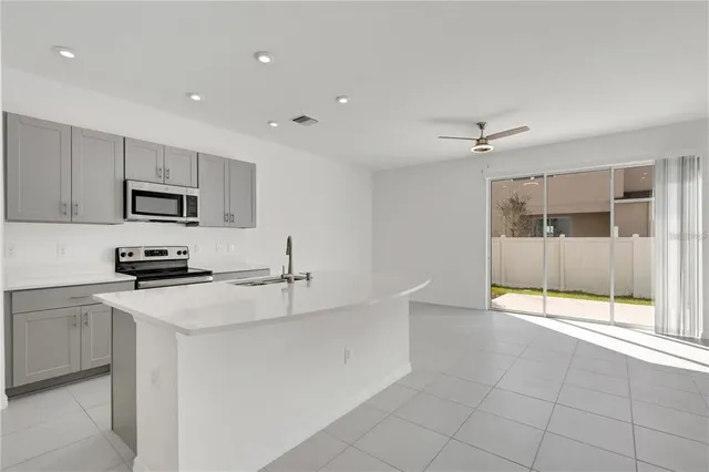 a kitchen with appliances cabinets and a sink