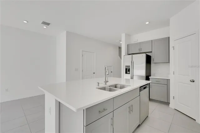 a kitchen with a sink cabinets and stainless steel appliances