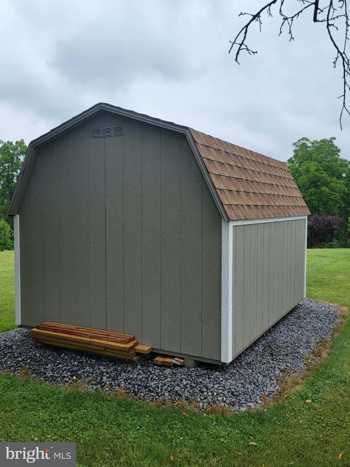 7296 Thompson Road Needmore, PA 17238 - Photo 38 of 40 Charming shed nestled in green landscape.