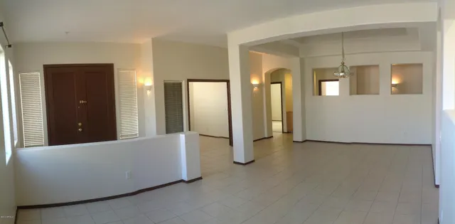 a view of an empty room with bathroom