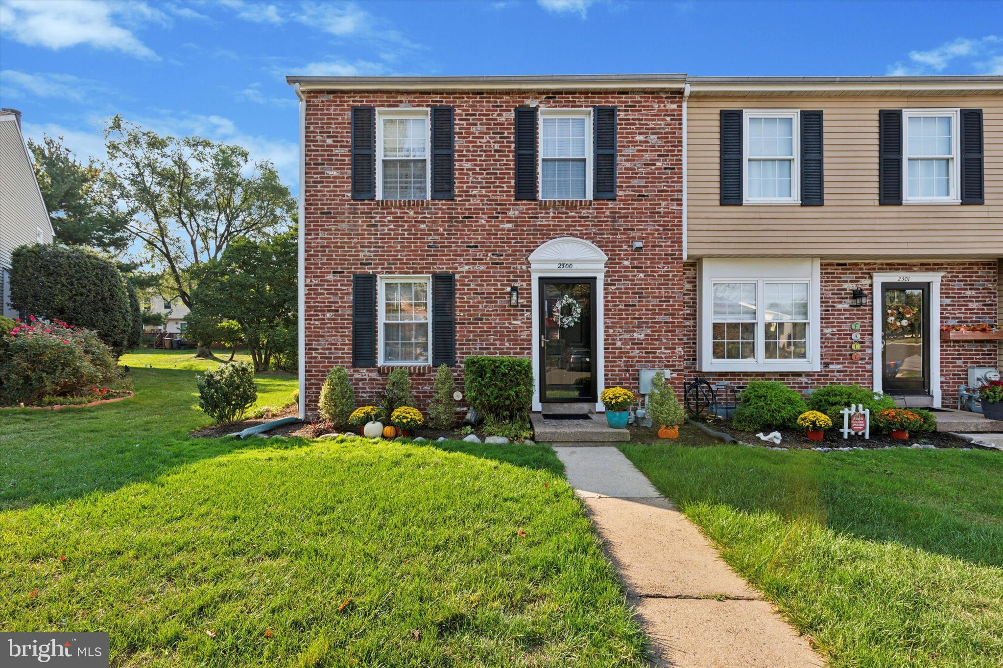 front view of a brick house with a yard