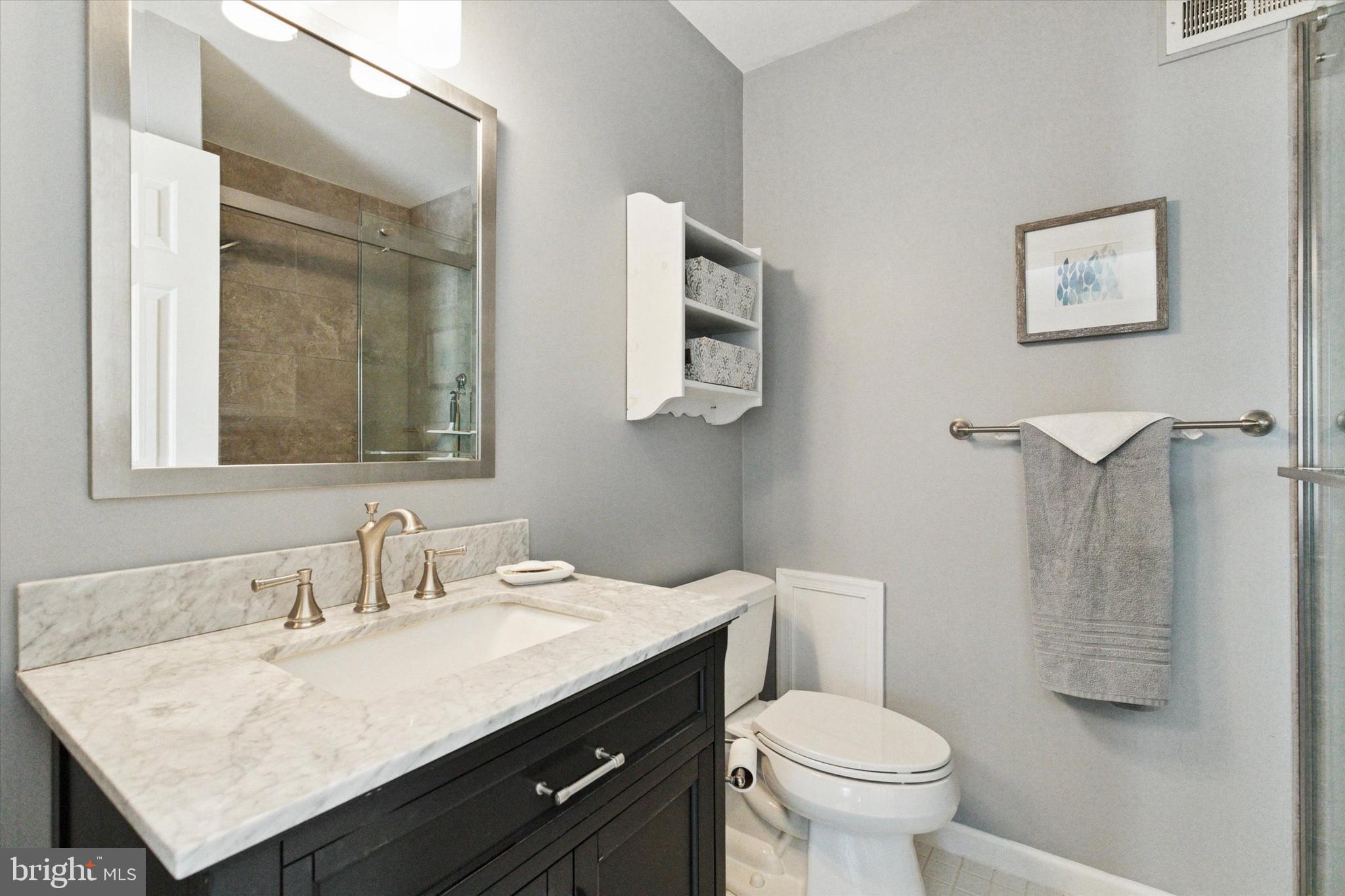 2300 Navajo Path Ambler, PA 19002 - Photo 15 of 25 a bathroom with a granite countertop toilet sink and mirror