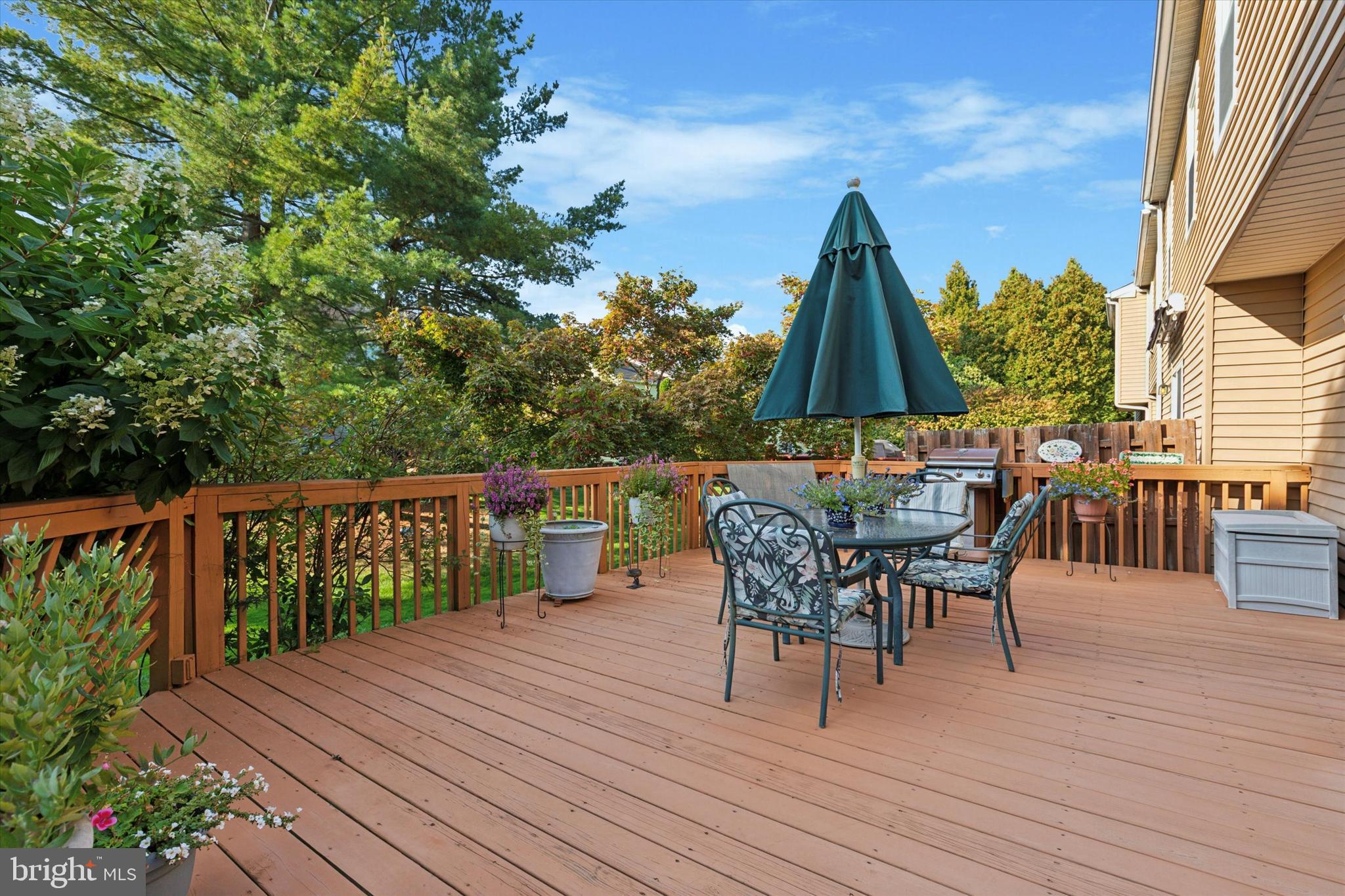 2300 Navajo Path Ambler, PA 19002 - Photo 22 of 25 a view of a roof deck with table and chairs a barbeque with wooden floor and fence