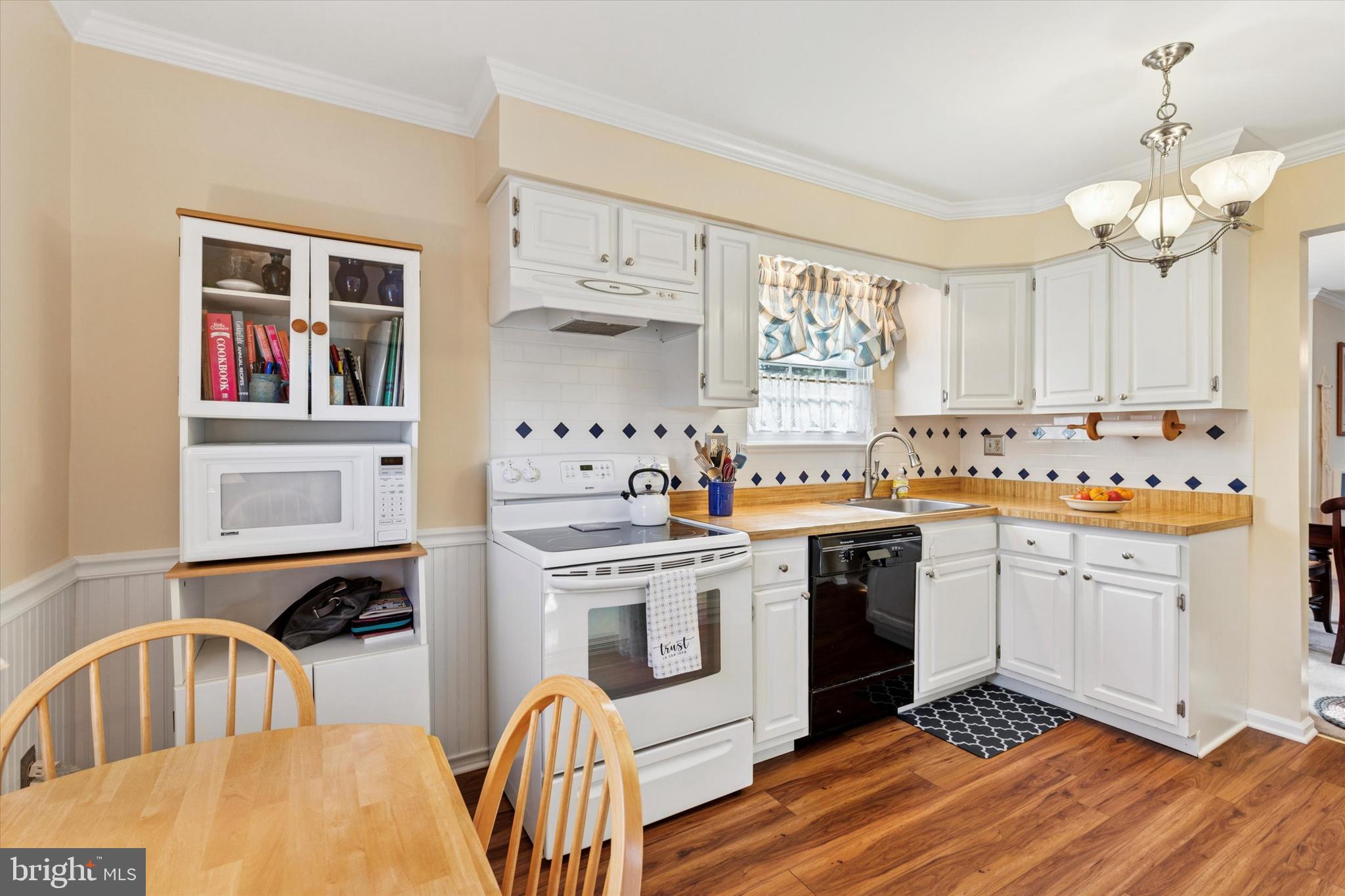 2300 Navajo Path Ambler, PA 19002 - Photo 4 of 25 a kitchen with stainless steel appliances granite countertop a stove a sink dishwasher and white cabinets with wooden floor