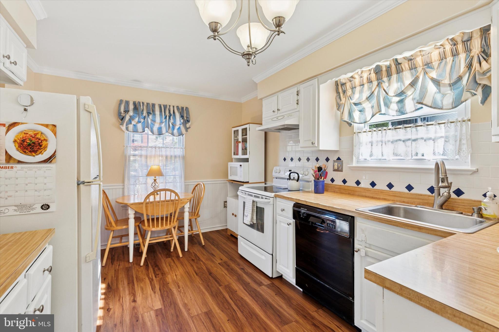 2300 Navajo Path Ambler, PA 19002 - Photo 6 of 25 a kitchen with a dining table chairs and a stove top oven