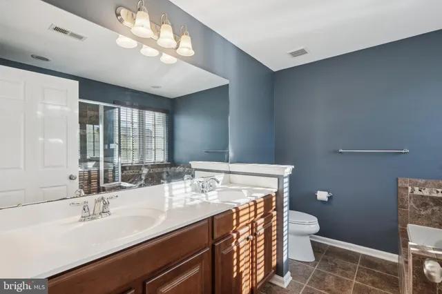 a bathroom with a bathtub and shower