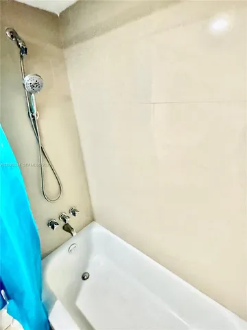 a bathroom with a tub and a shower