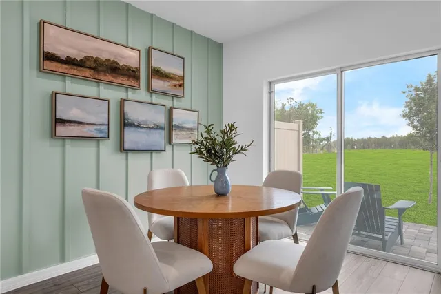 a view of a dining room with furniture and a potted plant