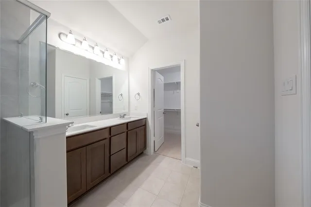 a view of an empty room with a ceiling fan and a window