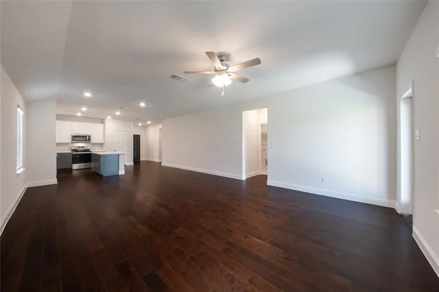 a view of kitchen and hall with wooden floor