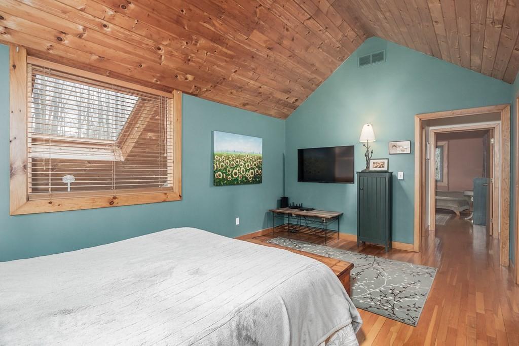 25 Hog Hill Road Pepperell, MA 01463 - Photo 17 of 34 a bedroom with a bed and a flat screen tv
