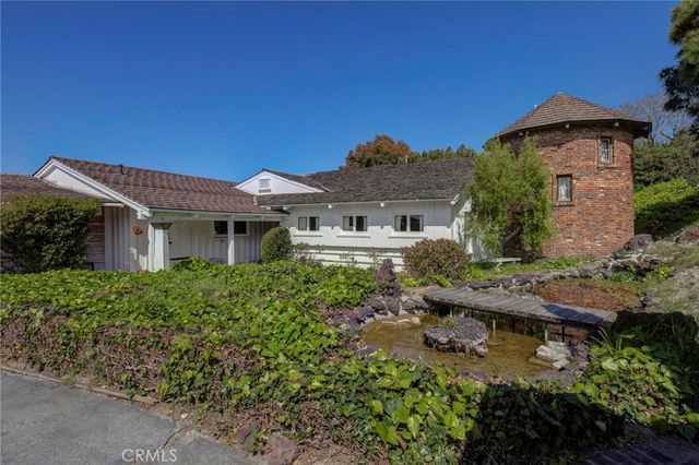 an aerial view of a house with swimming pool garden and patio