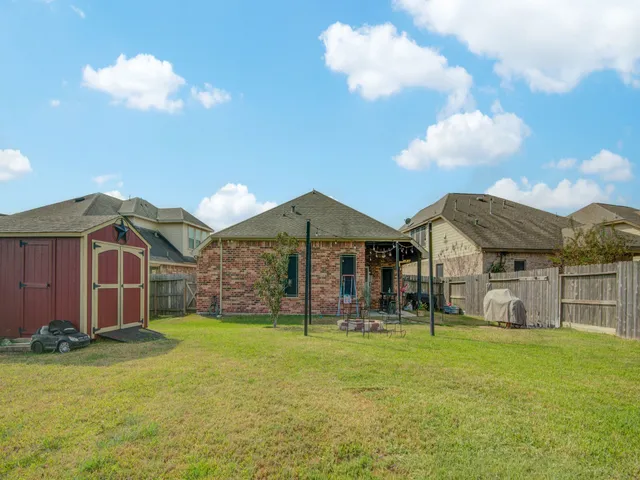 a view of a house with a backyard