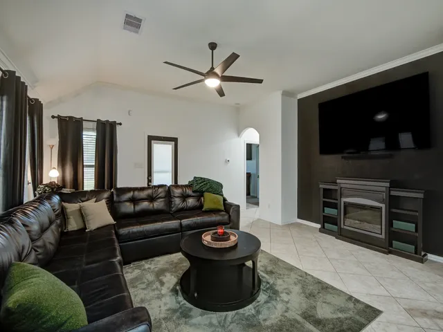 a living room with furniture and a potted plant