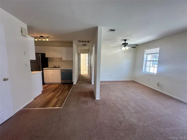 a view of a livingroom with a kitchen