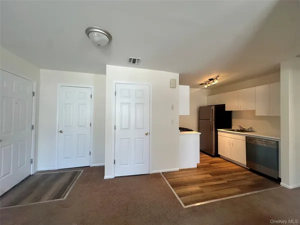 a kitchen with a refrigerator and a stove top oven