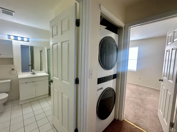 a view of a hallway with washer and dryer