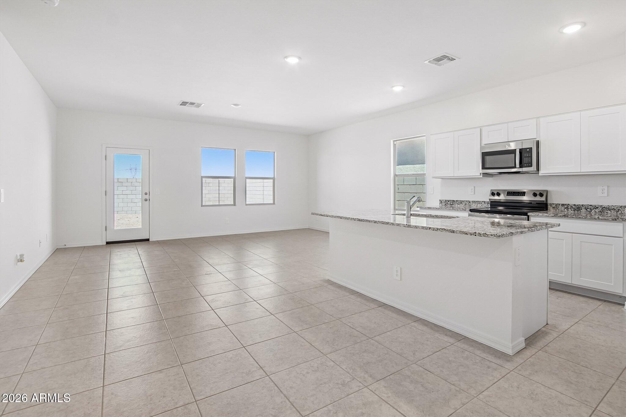 47235 West Old Timer Road Maricopa, AZ 85139 - Photo 5 of 23 SL_Moonbeam_Kitchen_Family_Room_B (1)