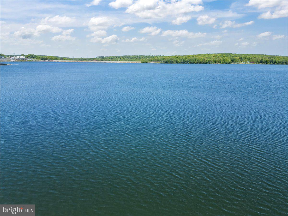 663 Bear Woods Road Mount Storm, WV 26739 - Photo 66 of 73 Serene waters under a blue sky.