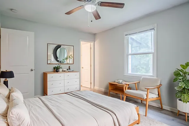 an empty room with a window and a fan