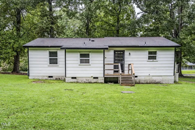 a view of a balcony with a yard