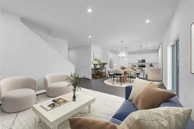 a living room with furniture and kitchen view